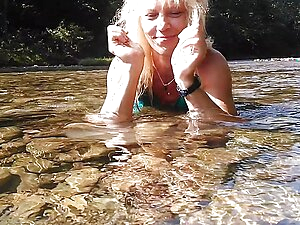 Sexy t-girl swimming in mountain river and wetting teal summer dress ...